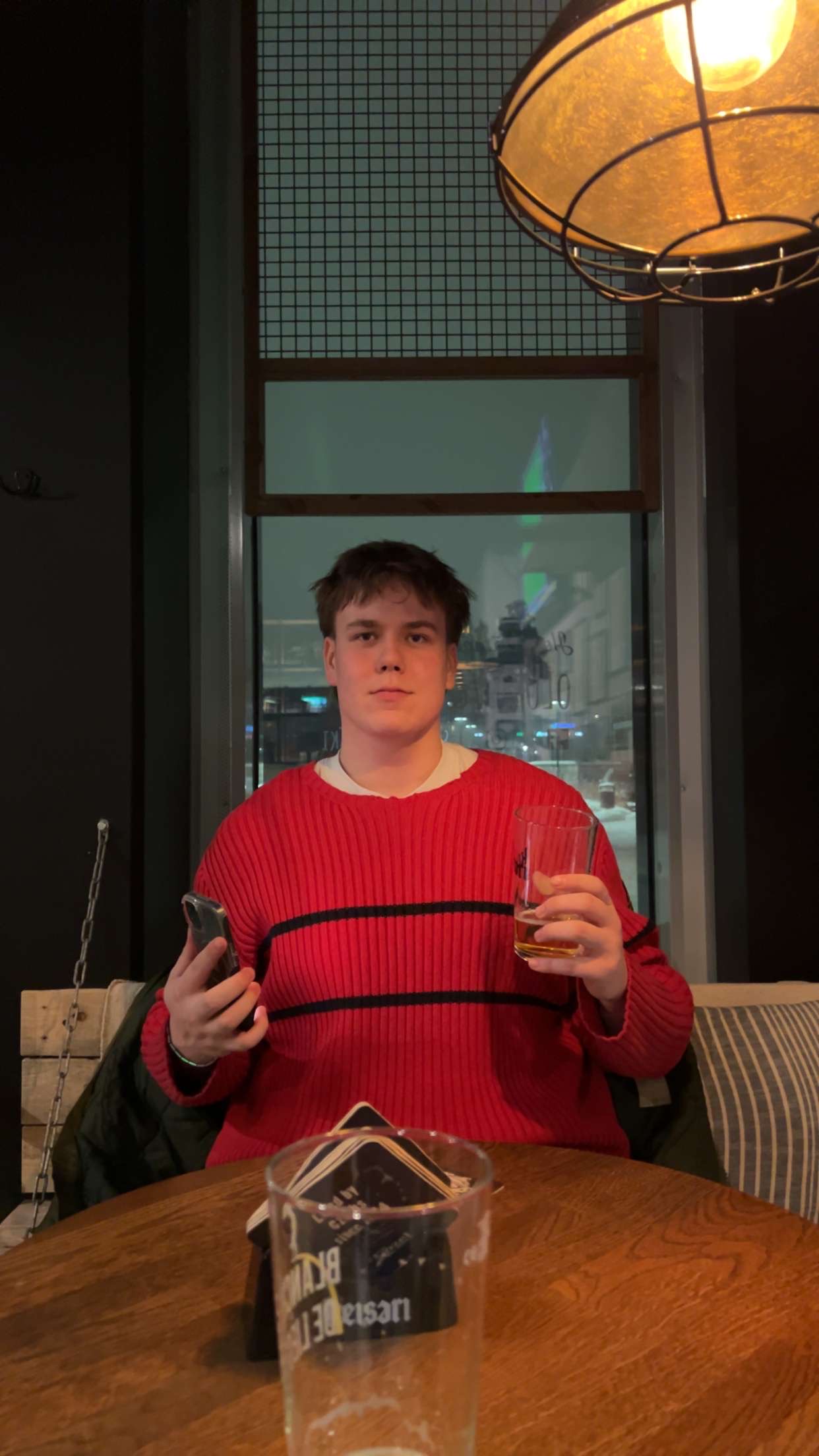 Lukas Lievonen, a student at Haaga-Helia Pasilan campus, smiling at the camera in an indoor setting